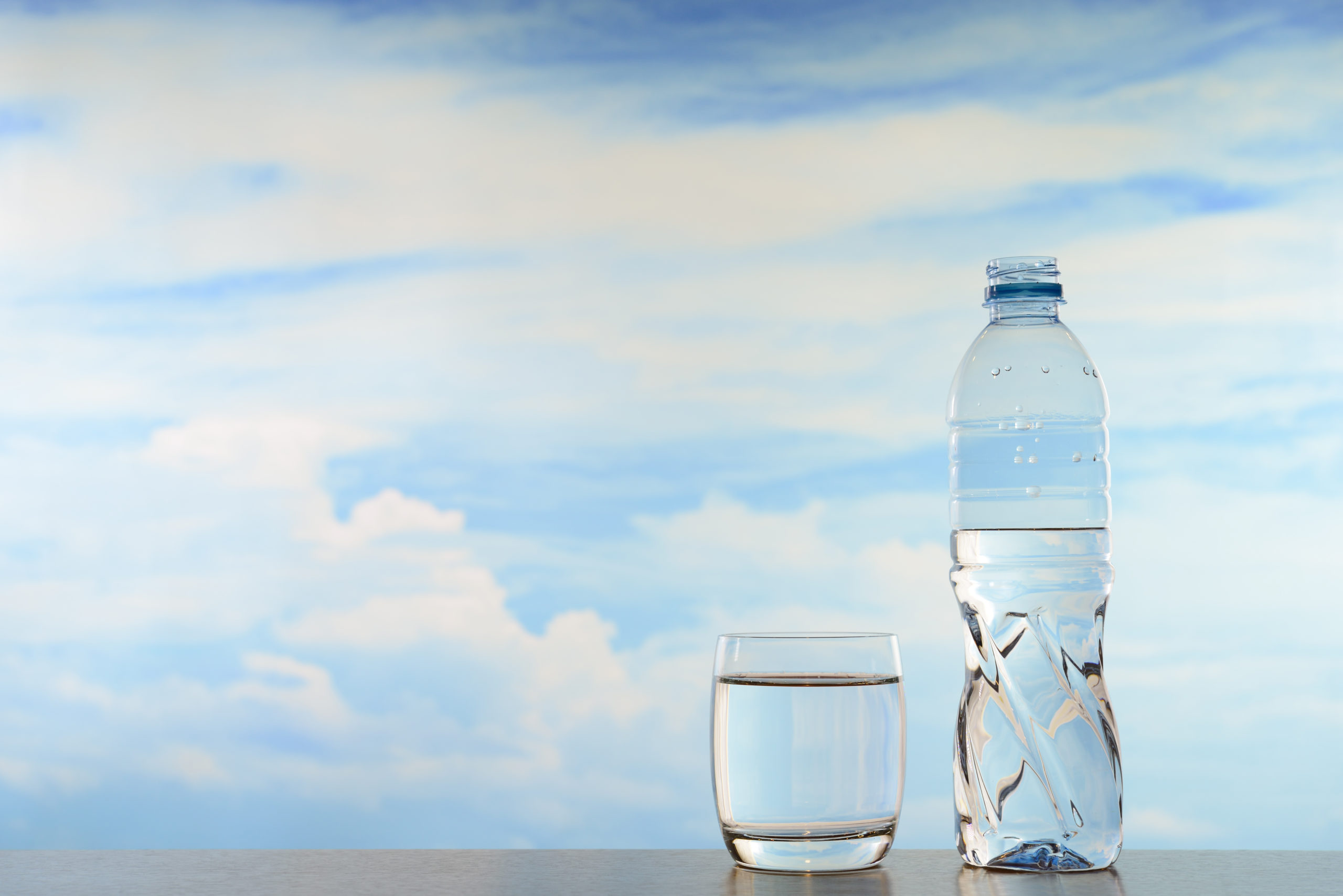 BOTTLE OF WATER WITH GLASS